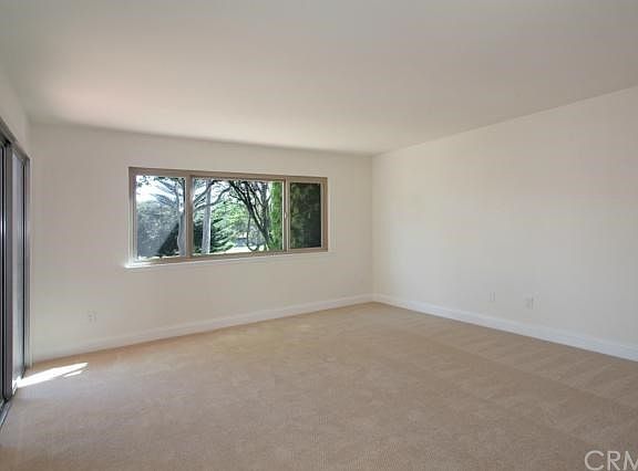 Carpeted master bedroom with sliding door out to patio.  Beautiful view of golf course and green belt.