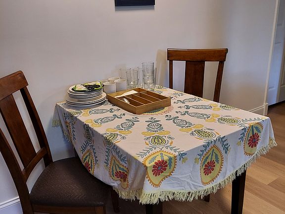 Two chairs at the table that is large enough to share a meal or spread out your home office work