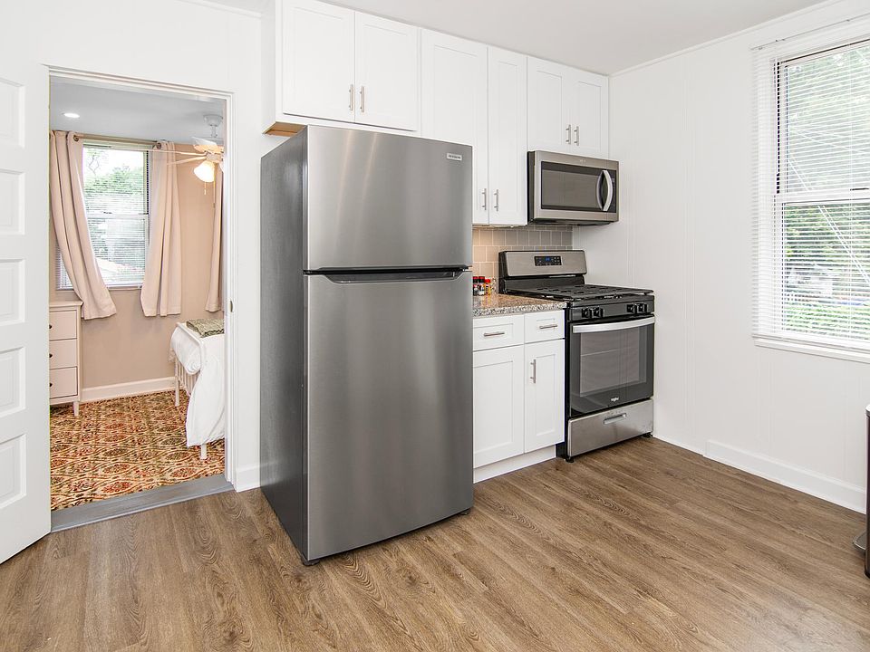 Kitchen with refrigerator, stove and microwave