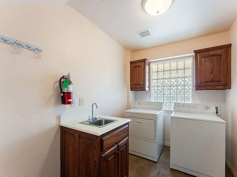 Laundry room with washer and dryer on first floor