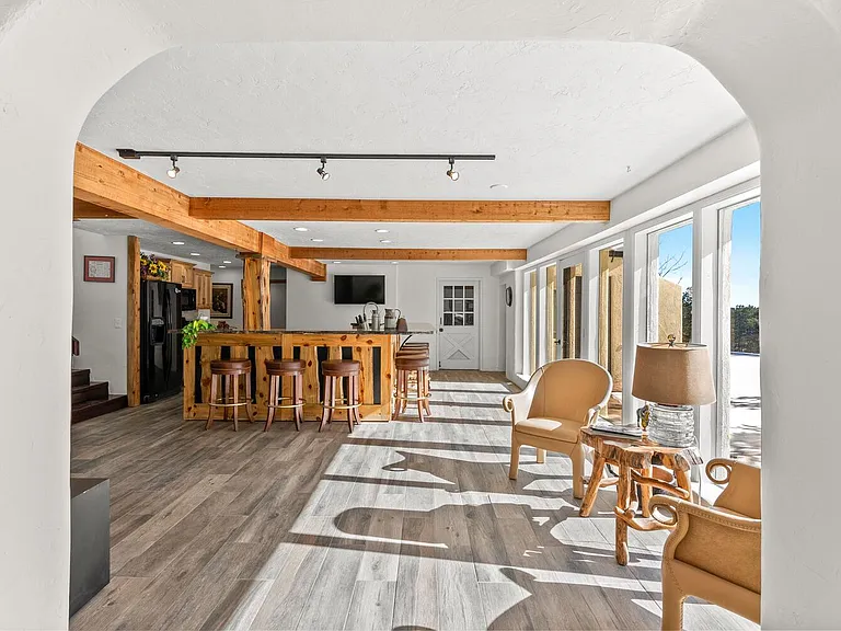 Side View of the Kitchen/Sitting area. Large windows opening up to the private side yard