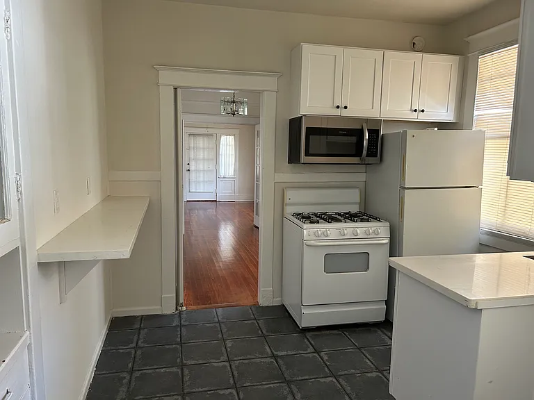 Third room is the kitchen
Kitchen has stove, refrigerator, microwave.