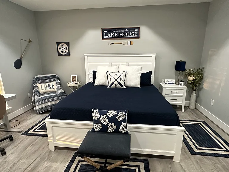 Master bedroom with TV, desk, gas fireplace and En suite bathroom with vaulted ceilings and a fan.