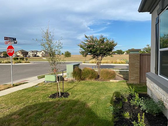 Corner of the house, showing the street and open Park area.