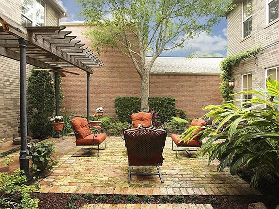 Bricked courtyard with lush landscaping and sprinkler system.  A perfect retreat!
