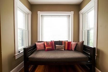 Day bed in bay window offers semi-privacy for two sleeping a