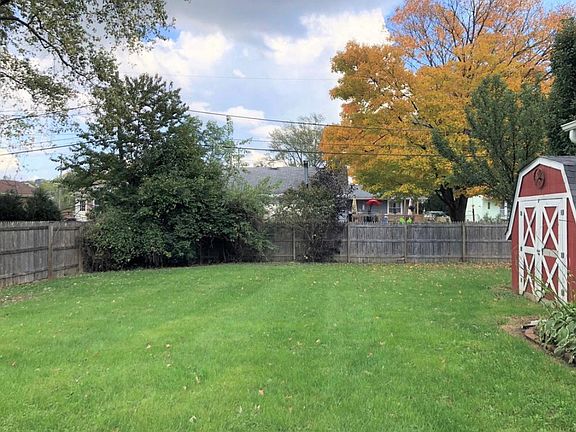 Large, fenced-in back yard with storage shed