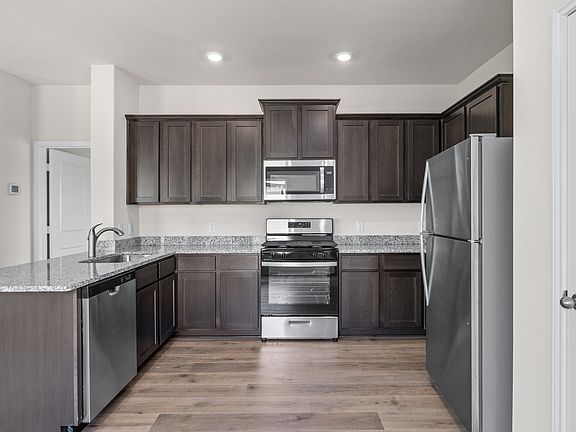 The kitchen has energy-efficient, stainless-steel appliances.