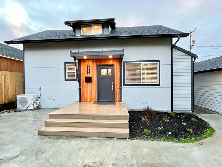 Curb appeal, elevated: Explore the entrance to your retreat with our three-step stairs. Nice little open patio to the left of the front door to hang out