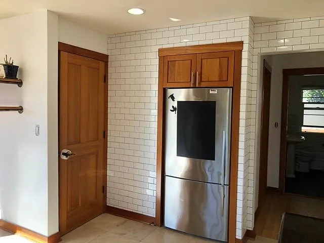 Floor to ceiling subway tiles in kitchen and bathroom