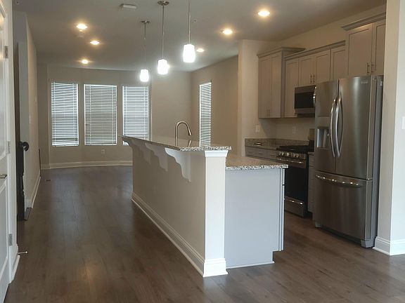 Large dining area looking into kitchen and great room with luxury vinyl plank floors