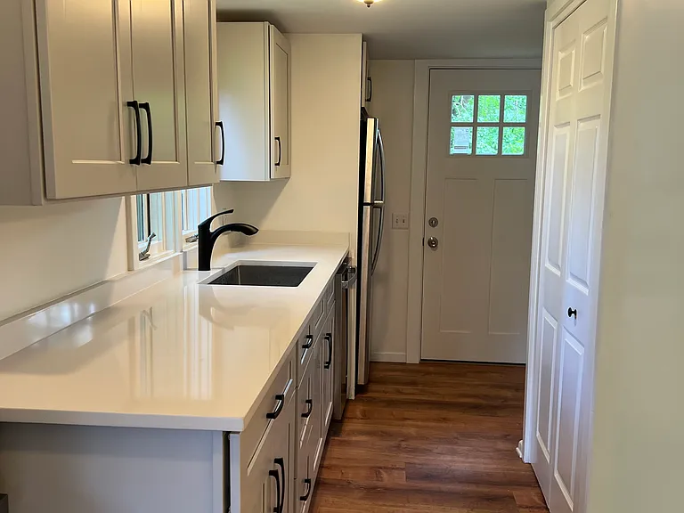 Kitchen with pantry leading to back yard