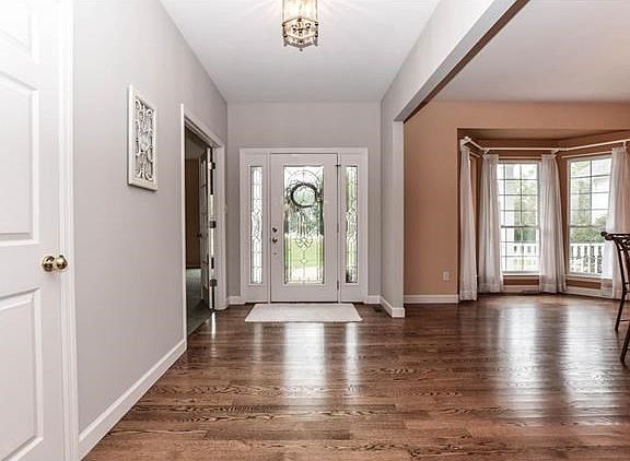 Large light filled entry with beautiful wood floors