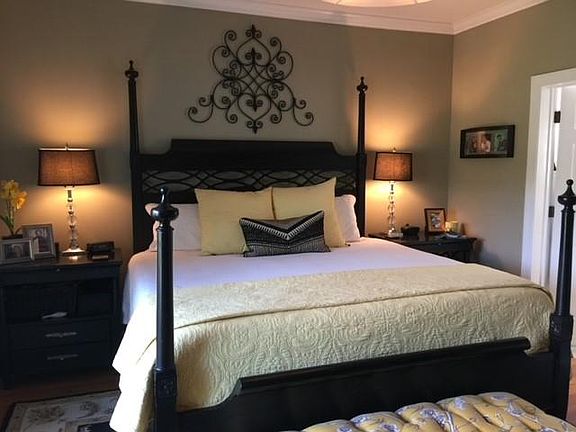 Large master bedroom with doors out to porch overlooking 4th and 5th fairways of the Links at Stono Ferry