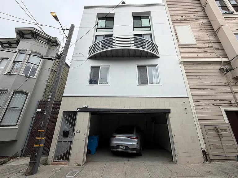 front of building with 2 cars side by side garage