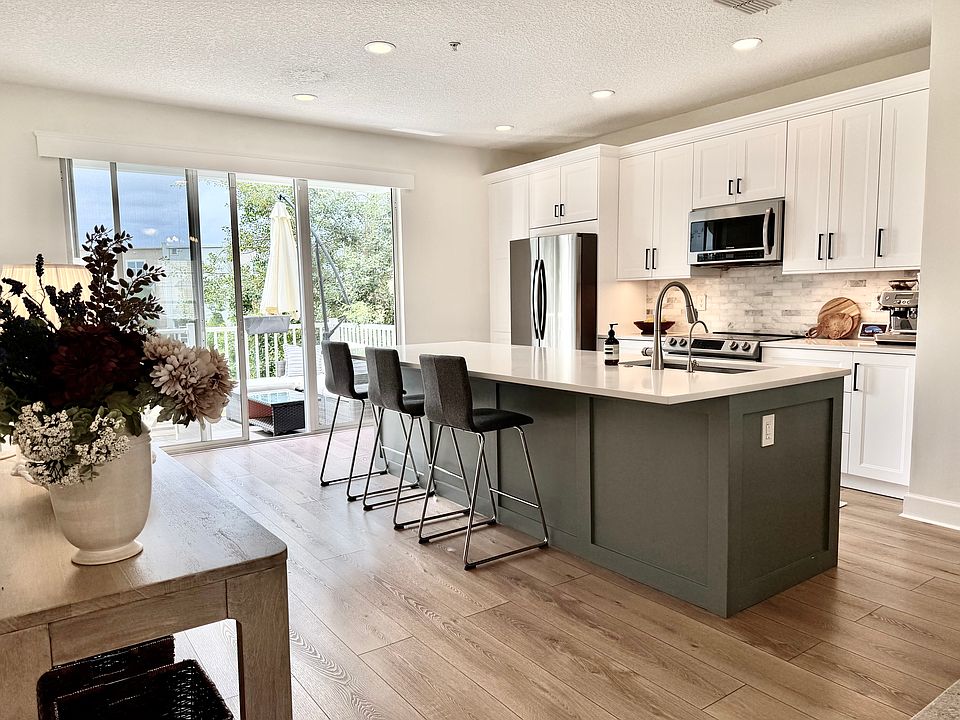Open concept kitchen with updated appliances and quartz counter tops
