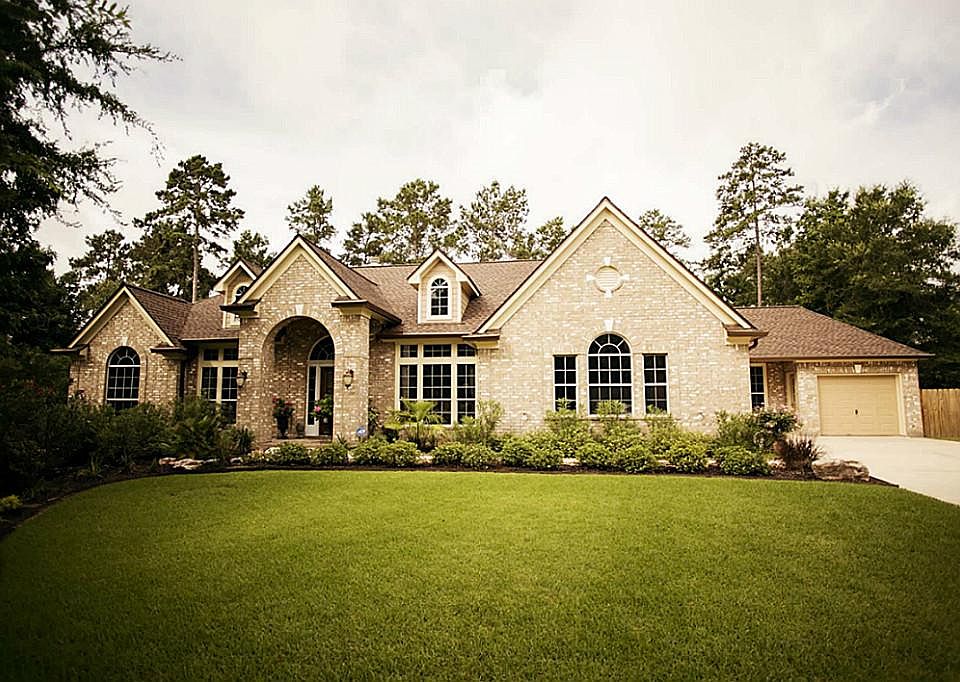 Gorgeous brick elevation with long driveway to the three car garage.