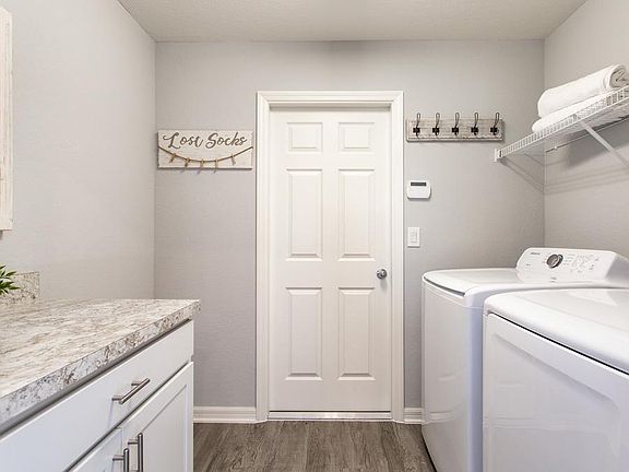 Laundry area with convenient drop-zone for additional organization and storage - New home for sale i