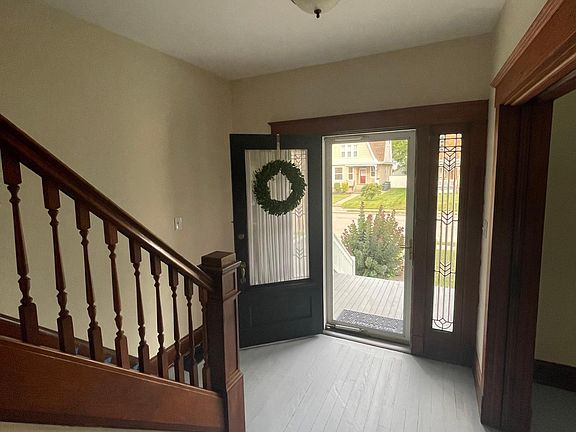 Front entryway with hall pass through to kitchen. Pocket doors opened to living room and family room.