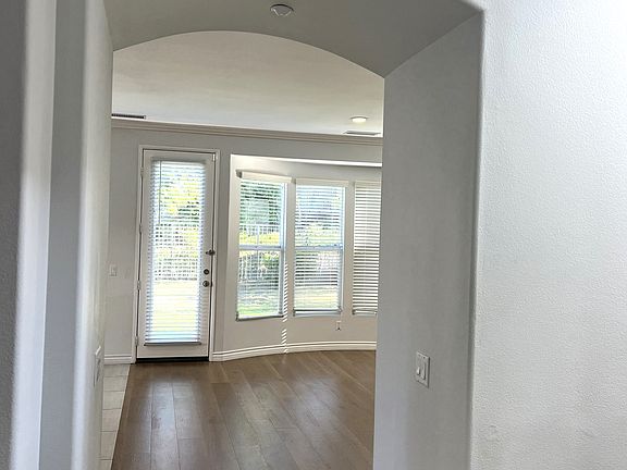 Archway to kitchen, downstairs family room and dining room