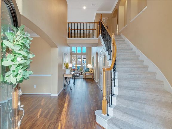 Dramatic two story entry, sweeping staircase and gorgeous laminate flooring.
