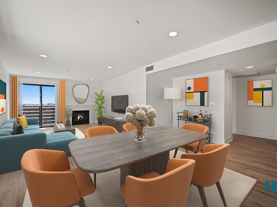 Open-Concept Dining and Living Room with Vinyl Flooring, Recessed Lighting, Electric Fireplace, and Patio