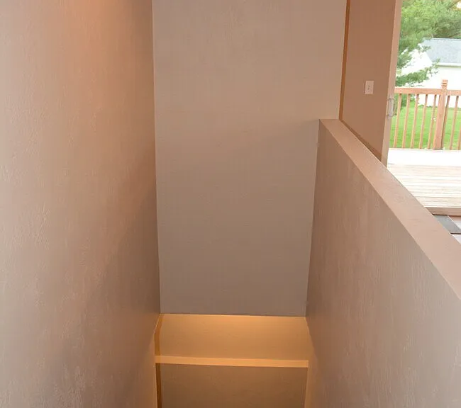 Stairway leading to additional rooms and storage.