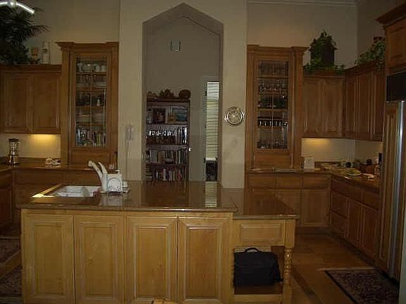 The cabinetry, custom, crown molding and fluted columns set this hom