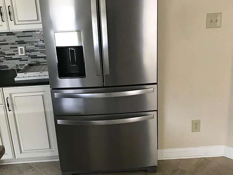 Stainless appliances with refrigerator including ice maker, middle drink drawer, pizza slots and sectioned drawers