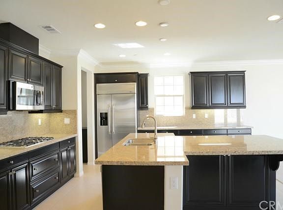 Main kitchen with full granite backsplash and built in Monogram refrigerator