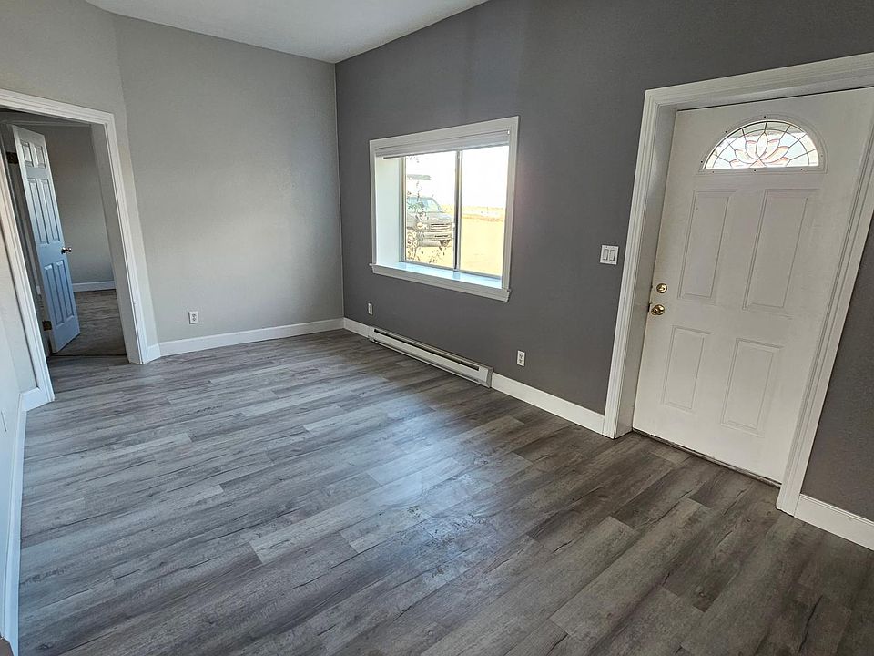 Living room with front entry door on right