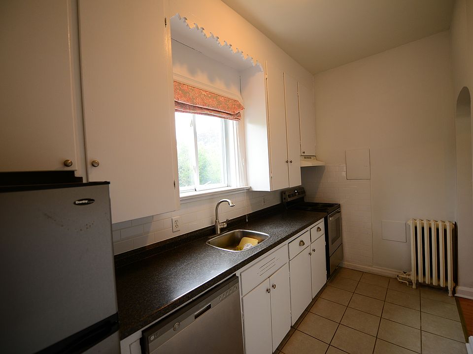 Kitchen with large cupboards and 10 ft ceilings. Comes with refrigerator, stove, range and dish washer.