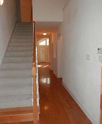 GORGEOUS WOOD FLOORS AND SOARING CEILING IN ENTRY