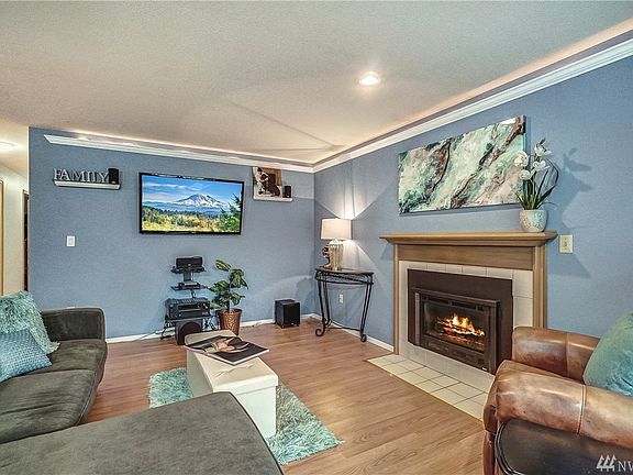 Spacious great room design... Lives well! Gas fireplace, easy-to-care-for laminate flooring, nice lighting, colors, moulding det