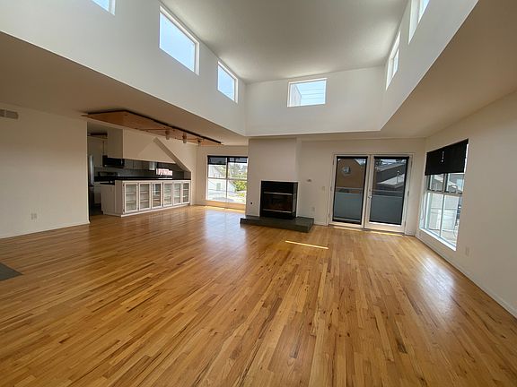 living room w high ceilings giving lots of natural light