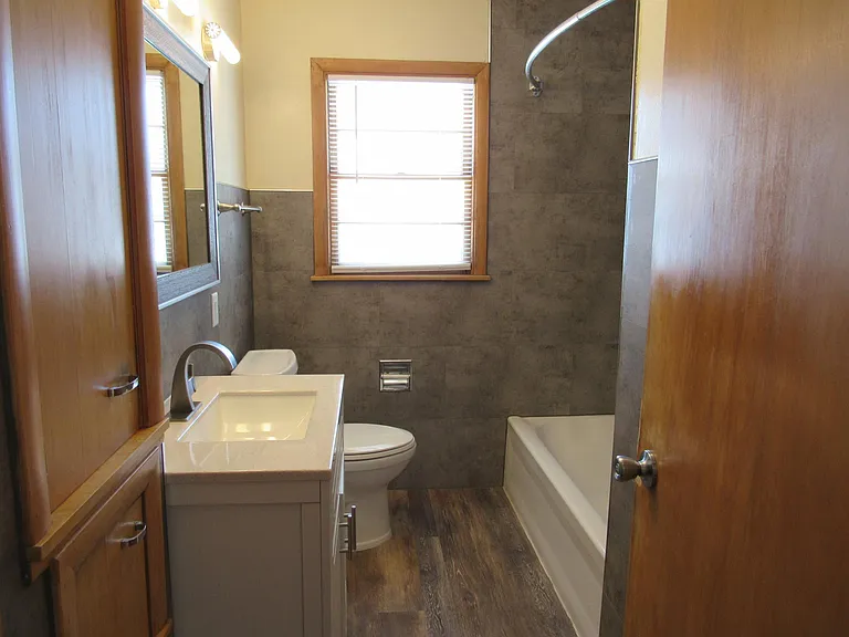 Bathroom- New tub and shower. New vanity and toilet. New flooring