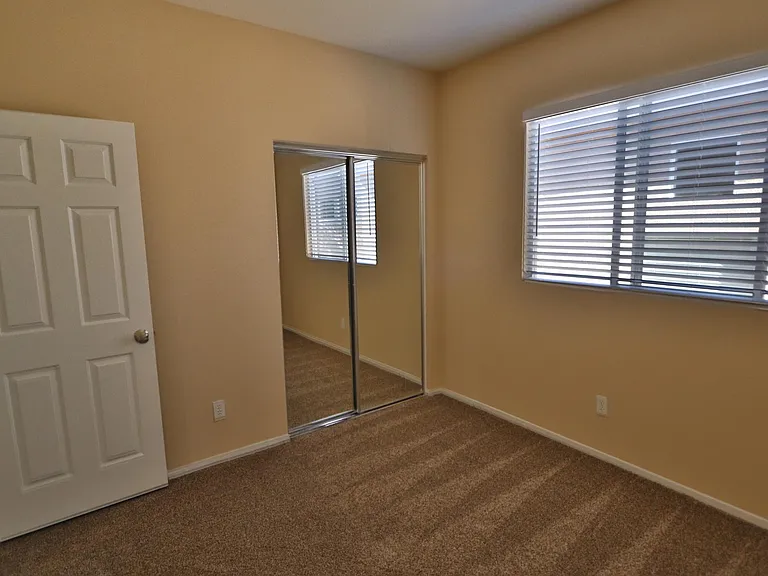 2nd bedroom includes closet organizer and new cordless blinds