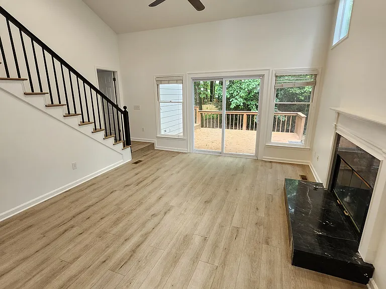 Family room with fireplace and cathedral ceiling. Stairs leading to the loft