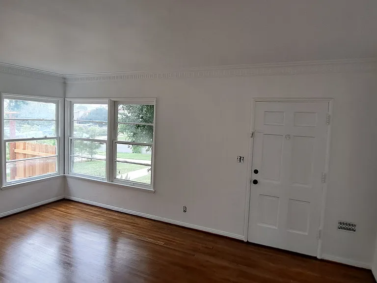 Living room with faux fire place heater, New hardwood floors oak, will have window ac unit with wifi access. Size is 12'x18' sq feet. 

Here is walk through video of the unit:
