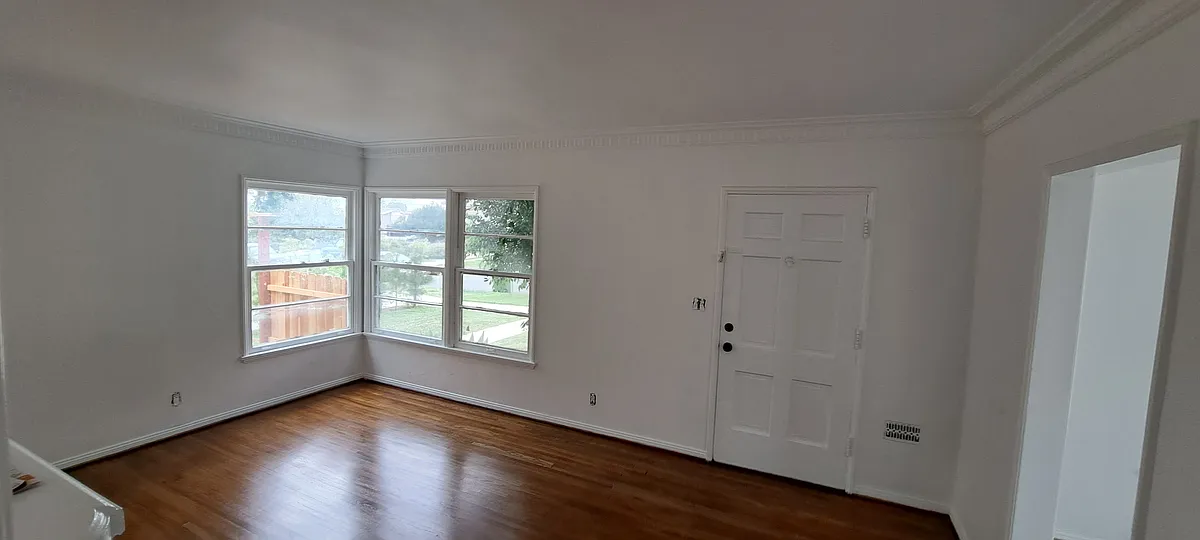 Living room with faux fire place heater, New hardwood floors oak, will have window ac unit with wifi access. Size is 12'x18' sq feet. 

Here is walk through video of the unit: - 1534 S Spaulding Ave #1