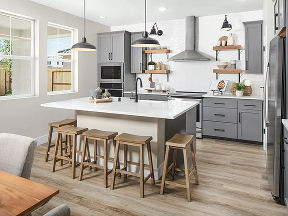 Kitchen with pendant lighting and floating shelves