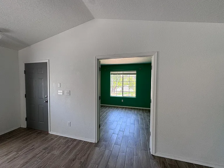 Living room looking into office and front door