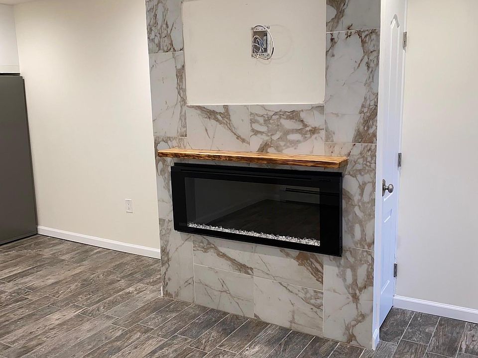 Electric Fireplace in Living Room with Coat Closet and Pantry Closet behind