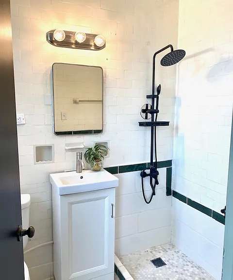 Private bathroom off primary bedroom features custom tiled shower.