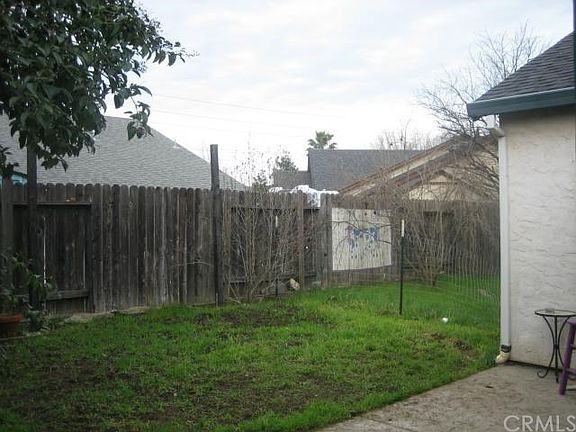 Nice size back yard with pomegranate tree.