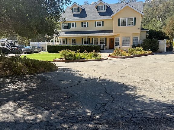 Main house. Studio to the left on second floor. Peeking under the oak tree, you can see parking and entry gate.