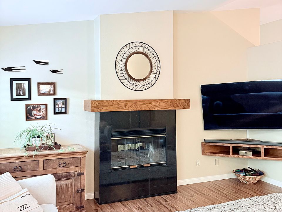 Living room with dual sided gas fireplace and built in media shelf