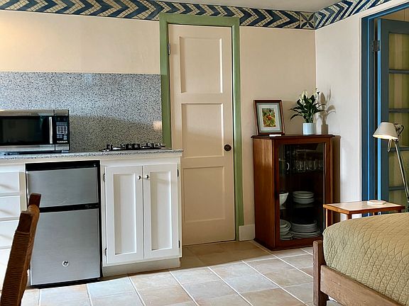 Orderly kitchenette w/beautiful recycled blue glass countertop by New Zealand designer!, Miele burners, Cuisinart Microwave, spacious Oster Oven.
Pantry closet w/ appliances, serving dishes, space for snowboard/golf clubs.