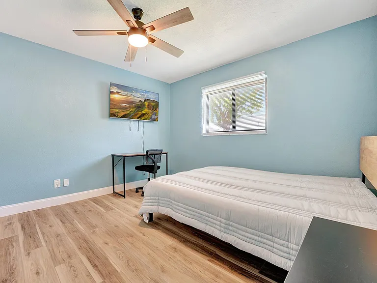 Bedroom with desk, tv and closet