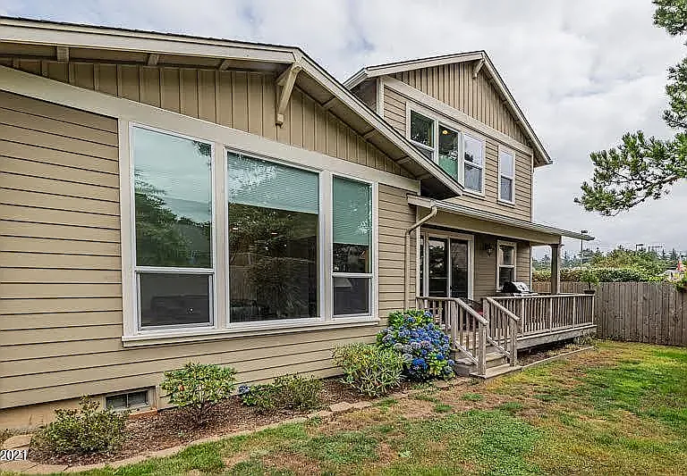 Back South Side of House with Covered Porch and Landscaping.